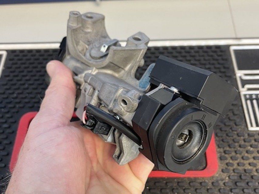 Technician holding a removed ignition cylinder in Sacramento